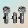 Wireless lapel mic dual pack showing two clip-on microphones with windscreens and Lightning receiver on gradient background